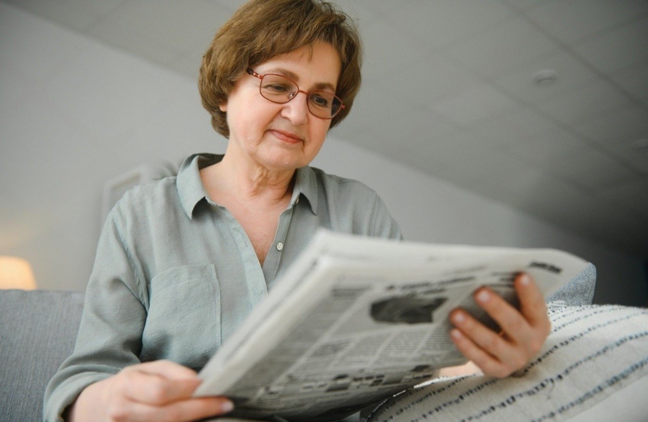 stock-photo-older-woman-eelaxing-and-reading-newspaper-2197082191 (1)